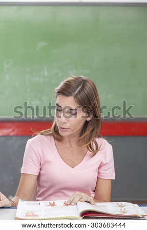 The teacher reading a book