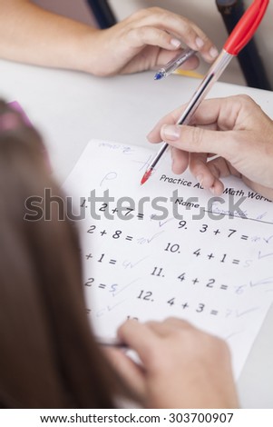 the teacher teaching and checking the homework
