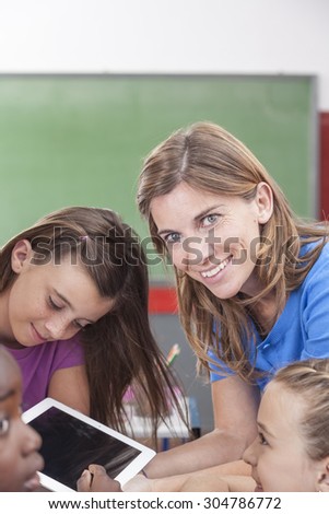 the teacher showing something and looking at camera
