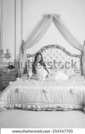 black and white European beautiful pregnant girl standing in a studio interior, naked in pink or purple robe, looking at camera, smiling, happy