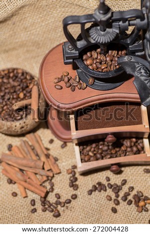 coffee beans, ground coffee, cinnamon, old wooden coffee grinder