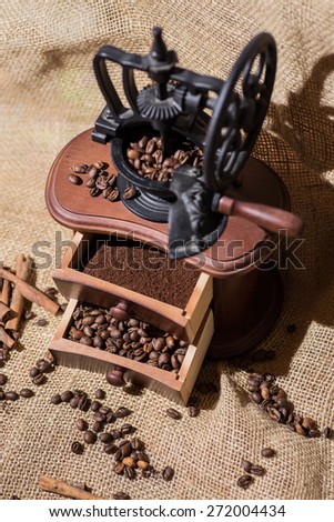 coffee beans, ground coffee, cinnamon, old wooden coffee grinder