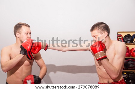 male kick boxer exercising with his instructor