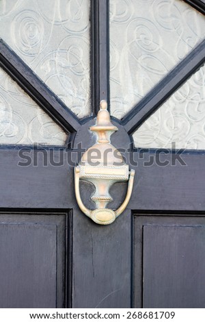Black door, window and silver door knocker