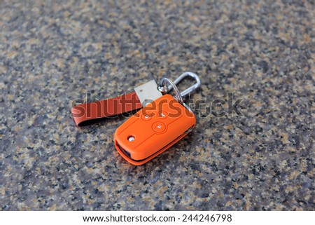 orange key car on the stone background