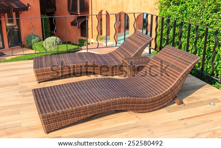 brown bamboo bed beside the swimming pool