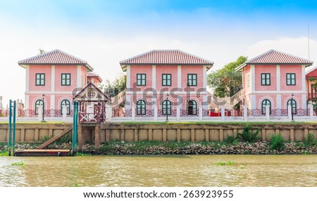 pink house in line beside the river in nature background