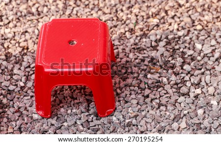 red short stool on stone floor nature background