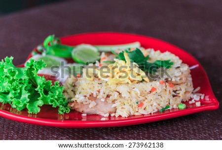 Fried rice on the red dish in heart shape on table