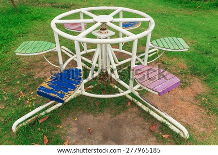 old playground equipment on the green grasses in the garden