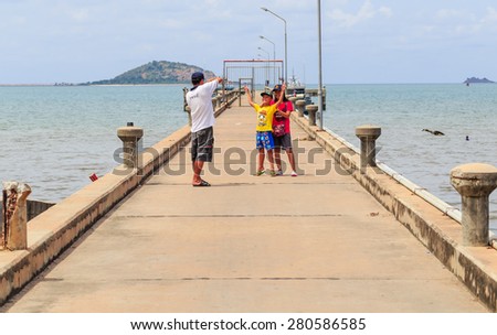CHONBURI - MAY,23 : The cement port has good view of sea nature. There are many people come to take photo in holiday that is happy family time.