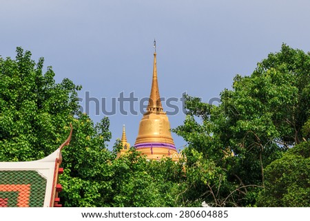 view of the golden pagoda on the hill in blue sky