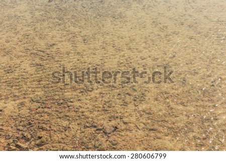 clear water can see the brown sand floor of the sea
