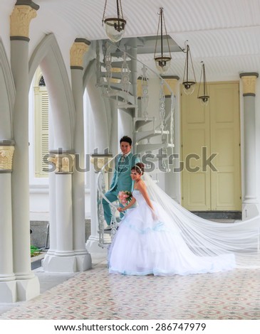 SINGAPORE-JUNE,13: The wedding couple is taken photo for prepare in wedding ceremony . This place is nice view for memory of love where public church in city . SINGAPORE JUNE,13 2015