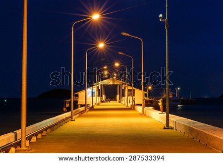 view of port and light pole in night time nature backgrond