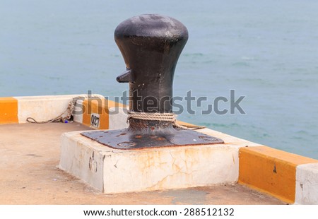 black big mooring stand alone on the port nature background