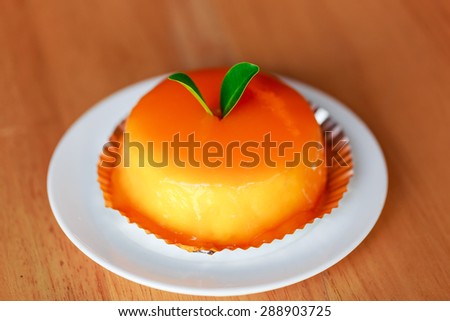 nice orange cake on wood table