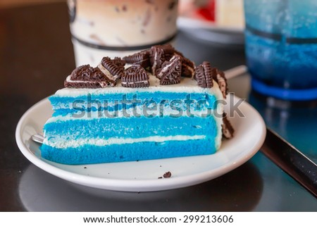 Blue cream cake and cookies on white dish