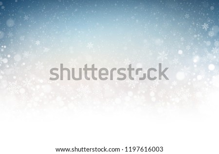 Snowflakes and snowfall on a cold blue winter background