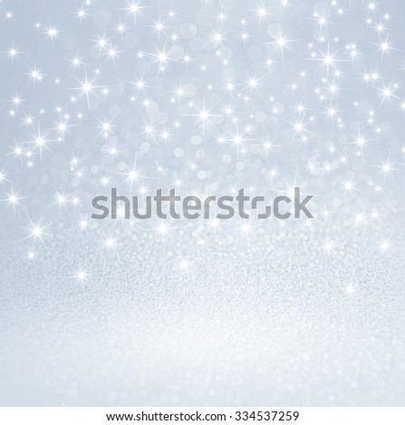Festive bright lights and shiny stars on glitter silver background