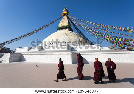 Nepal, Kathmandu -17th of December 2013: Tibetan Buddhist monks walking around Boudhanath stupa during festival