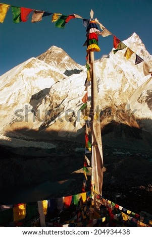 evening view of Everest with buddhist prayer flags from kala patthar and blue sky - way to Everest Base Camp - Nepal