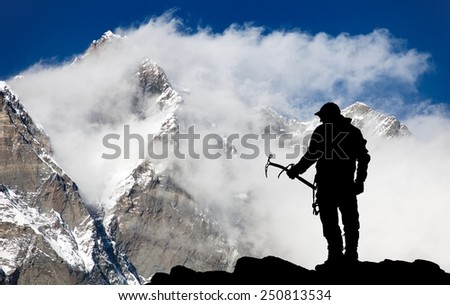 Mount Lhotse and silhouette of man wihh ice axe - way to everest base camp - Nepal