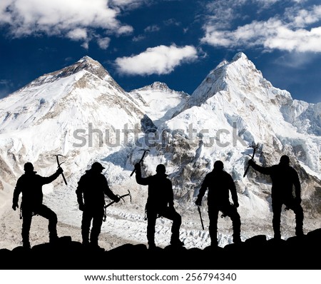 Mount Everest, Lhotse, Nuptse and icefall Khumbu from Pumo Ri base camp and silhouette of climbing men with ice axe in hand - trek to everest base camp - Nepal