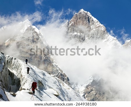 group of climbers on mountains montage to mount Lhotse, Everest area, Khumbu valley, Nepal