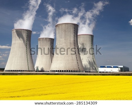 Nuclear power plant Dukovany with golden flowering field of rapeseed - Czech Republic - two possibility for production of energy