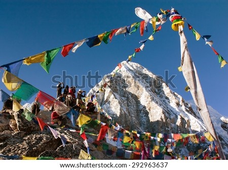 KALA PATTHAR, NEPAL, 9th NOVEMBER 2010 - Tourists with prayer flags on trekking mountain view point Kala Patthar and mount Pumo Ri. Kala Patthar is view point on Mount Everest in Khumbu valley.