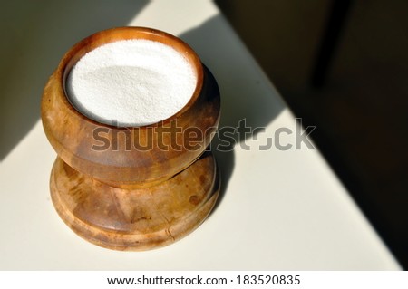 salt in wood salt cellar on the table
