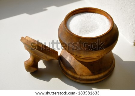 salt in wood salt cellar on the table