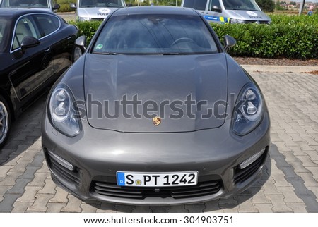 PRAGUE, THE CZECH REPUBLIC, 02.08.2015 - New Porsche Panamera parking in front of car store Porsche Prosek Prague