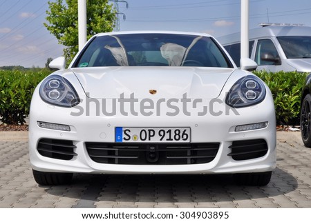 PRAGUE, THE CZECH REPUBLIC, 02.08.2015 - New white Porsche Panamera parking in front of car store Porsche Prosek Prague