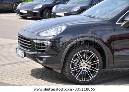 PRAGUE, THE CZECH REPUBLIC, 02.08.2015 - New Porsche Cayenne parking in front of car store Porsche Prosek