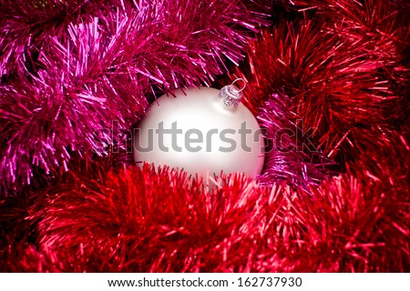 Christmas ball texture on shiny reflecting colorful chain texture