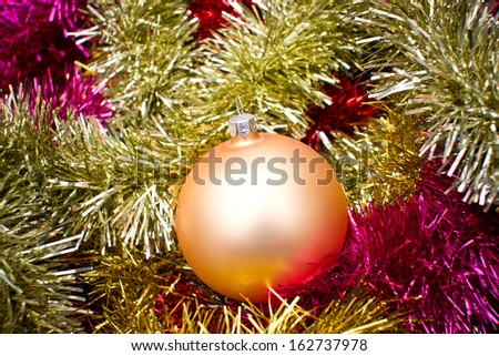 Christmas ball texture on shiny reflecting colorful chain texture