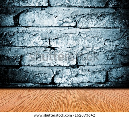 Grunge room with wooden floor and brick wall background