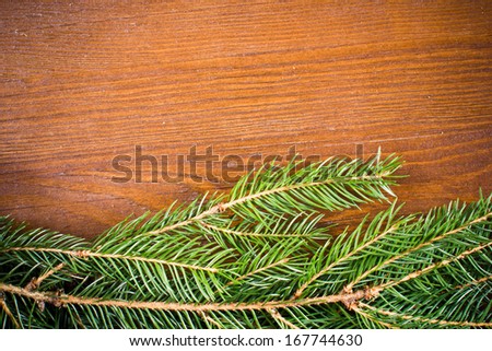 Christmas tree needles on wooden desk with blank space texture