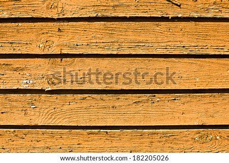Wooden desks covered with pale orange paint texture