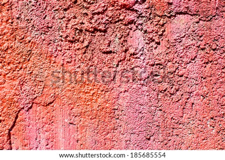Texture of painted rock wall in sunlight.