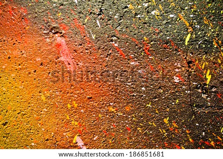Black,orange and yellow wall painted with spray - closeup texture.