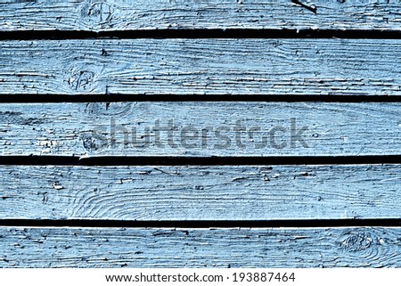 Wooden desks covered with pale blue paint texture