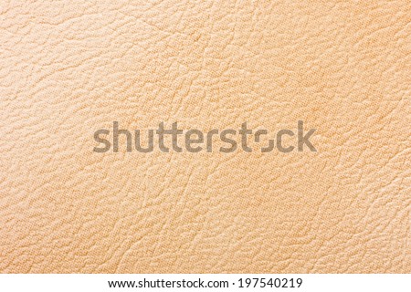 Macro creamy color leather texture.