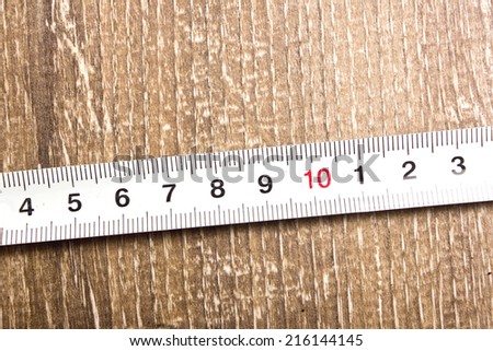 Measuring tape on wooden table texture