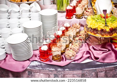 Wedding coffee table with cakes and fruits.