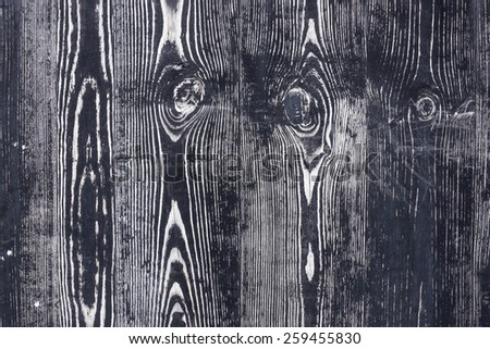 Black wood with knot texture.