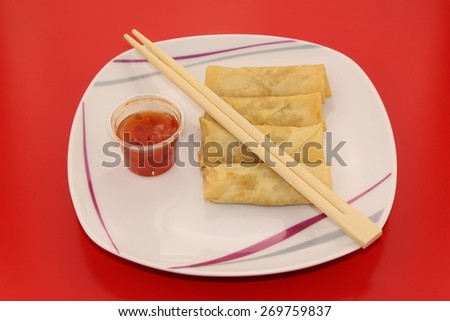 Spring rolls with sweet and sour dipping sauce on a plate