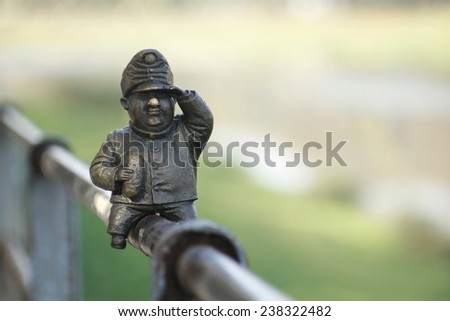 funny little bronze sculpture on the railing